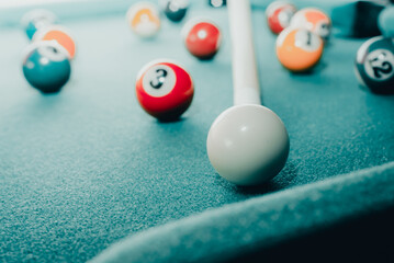 Sports game of billiards on a green cloth.Multi colored billiard balls in the form of a triangle...