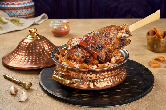 lamb shank fatta with red sauce tajin closeup