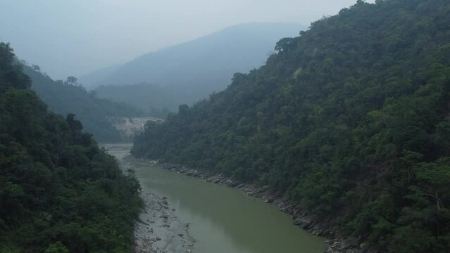 Teesta river flowing between the Sevoke valley, Siliguri, West Bengal. Shot from the Sevoke Coronation Bridge a landscape view