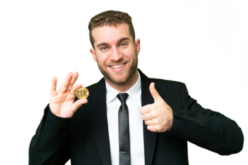 Young business blonde man holding a Bitcoin over isolated chroma key background giving a thumbs up gesture