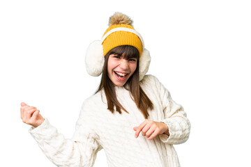 Little caucasian girl wearing winter muffs over isolated background making guitar gesture