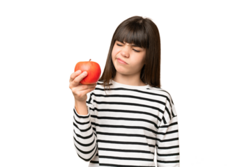 Little girl with an apple over isolated chroma key background with sad expression