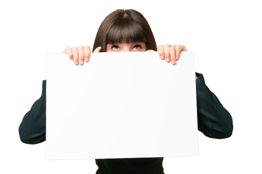 Little girl over isolated chroma key background holding an empty placard and hiding behind it