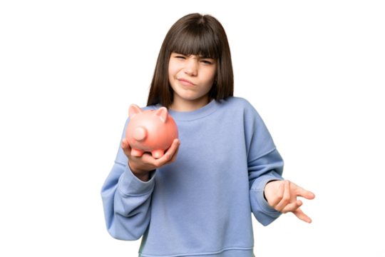 Little girl holding a piggybank over isolated chroma key background making doubts gesture while lifting the shoulders