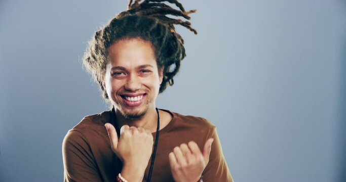 Happiness, music and face of man dancing, smile and having fun, groovy and celebrate at Jamaica party event. Portrait, energy and dancer celebration, rhythm or moving to radio on grey background
