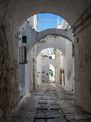 Ostuni, Italy - one of the most beautiful villages in South Italy, Ostuni displays a wonderful Old Town with narrow streets and alleys  - obrazy, fototapety, plakaty