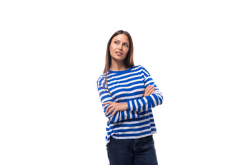 portrait of a young pretty caucasian woman with dark hair dressed in a blue striped sweatshirt on a white background. people lifestyle concept