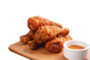 Crispy grilled chicken thighs and sauce on a wooden table transparent background