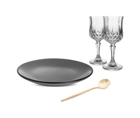 Clean plate, tea spoon and glasses on white background