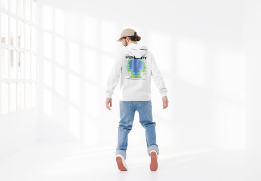 Mockup of man wearing customizable hoodie and cap, on tip toes