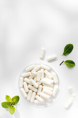 White capsules with minerals or food additives with an organic composition. Vitamins. Copy space