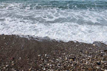 Low sea surf on a pebble beach. Montenegro