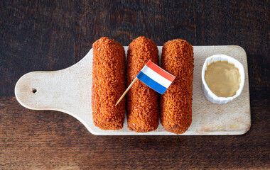 Traditional dutch kroketten served with mustard, a popular deep-fried fast food snack