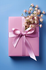 Top view of a pink gift box on a blue background. Congratulations on Valentine's Day, birthday or wedding