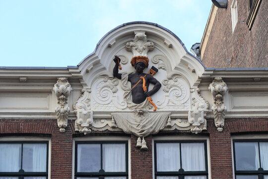 Rokin Street Building Facade Sculpted Detail with Black Man in Amsterdam, Netherlands