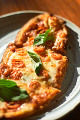 Sliced and served Italian pizza Margherita with basil leaves