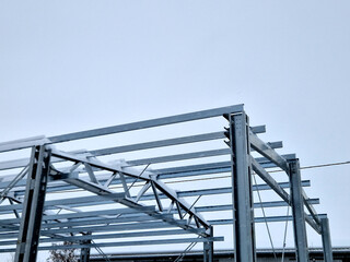 Building construction from metal trusses. lattice structure of the frame of an industrial building....