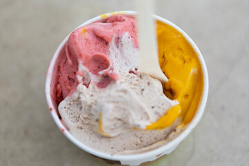 Gelato in three colors, strawberry, melon and plombir