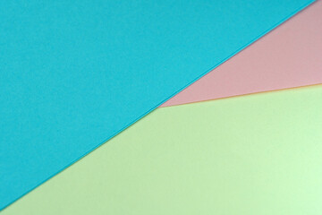 Sheets of colored paper lie at an angle