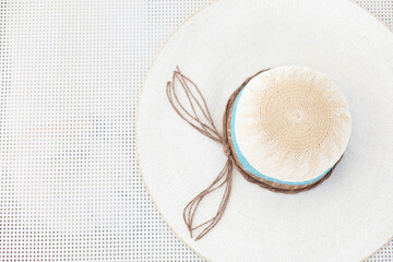 White summer hat on a white sunbed