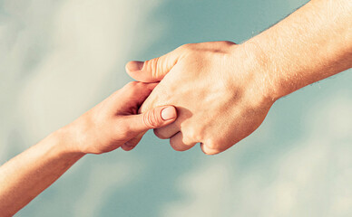 Lending a helping hand. Hands of man and woman reaching to each other, support. Solidarity,...