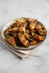 Homemade Bacon-Wrapped Jalapeno Poppers on a Plate, side view.