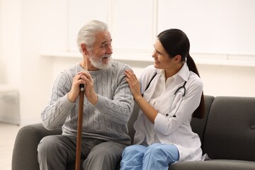 Health care and support. Nurse laughing with elderly patient in hospital