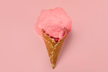 Melted ice cream in wafer cone on pink background, top view