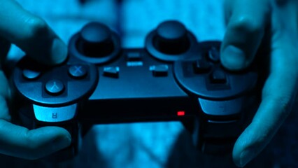 Hand playing on video game controller, close-up - Powered by Adobe