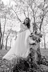 beautiful bride holding wedding autumn bouquet in nature. black and white