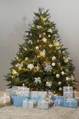 Many gift boxes under decorated Christmas tree in room
