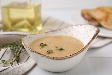 Delicious turkey gravy and thyme on white table, closeup