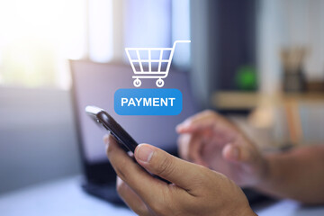 Mobile banking concept with hand using smartphone to touch on payment button and shopping cart for buy products or services via application in online store