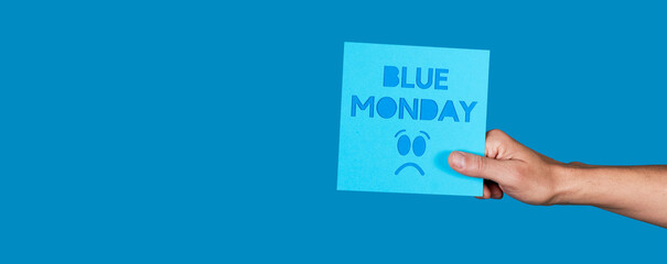 man with a sign with the text blue monday, banner