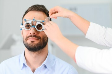man checking up vision with special ophthalmic glasses