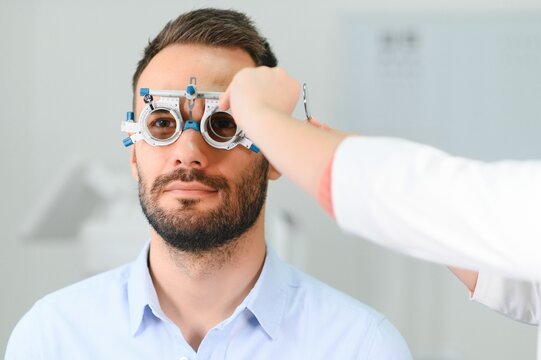 man checking up vision with special ophthalmic glasses