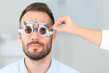 man checking up vision with special ophthalmic glasses