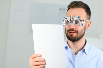man checking up vision with special ophthalmic glasses