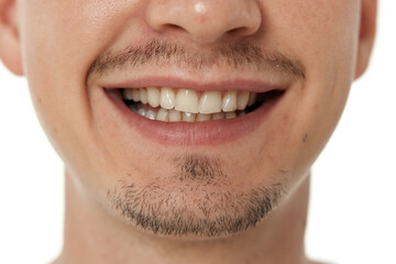 Fototapeta premium mouth and teeth of smiling man on studio background. male face with clean teeth