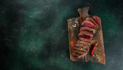 Beef steak meat at wooden cutting board, Menu, recipe mock up, banner. copy space for text. top view