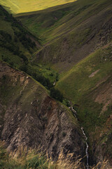 High mountain hilly valley with waterfall, Caucasus Mountains