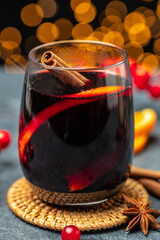 Hot red mulled wine in glass with orange, Traditional hot drink or beverage, festive cocktail