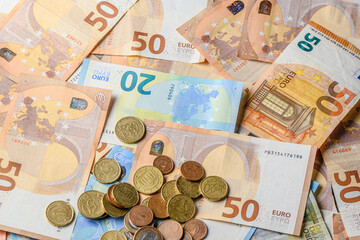 Euro bills and coins scattered on the table as a background 16