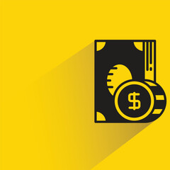 dollar banknote and coin with shadow on yellow background