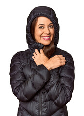 Middle-aged woman in black down coat in studio