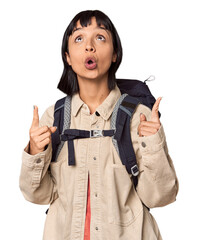 Young Hispanic with trekking backpack ready showing a disappointment gesture with forefinger.