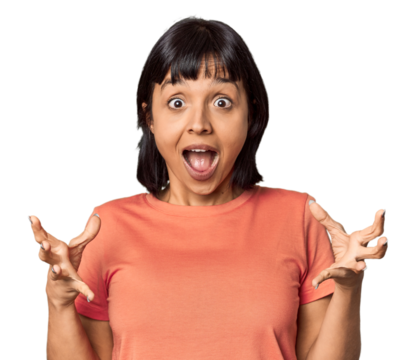 Young Hispanic woman with short black hair in studio screaming to the sky, looking up, frustrated.