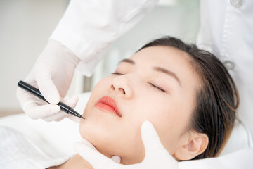 plastic surgery, beauty, Surgeon or beautician touching woman face, surgical procedure that involve...