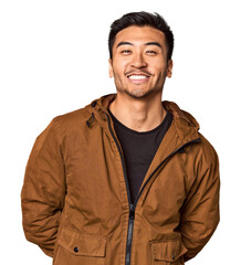 Obraz premium Young Chinese man in studio background happy, smiling and cheerful.