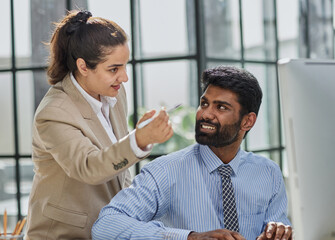 Working together on project. Two young business colleagues working on computer